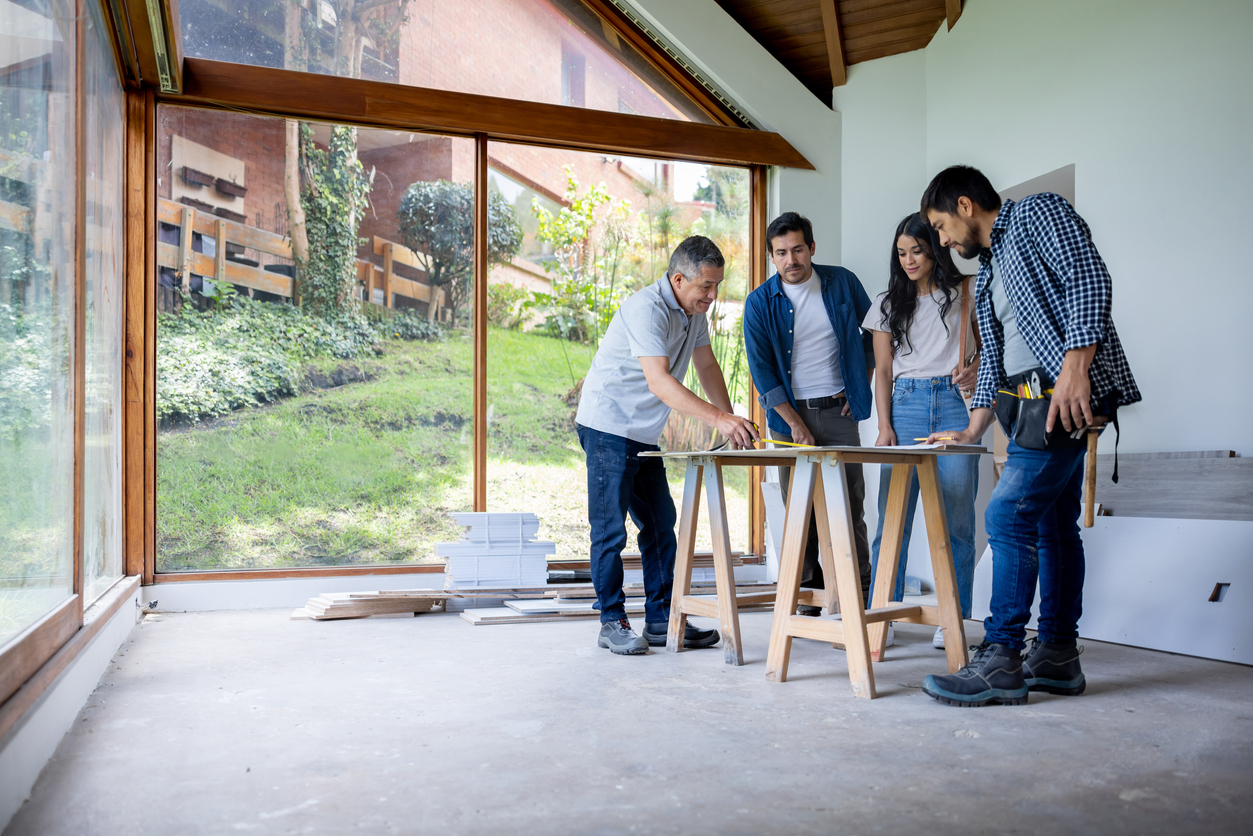 Couple remodeling their house and talking to their architect and building contractor